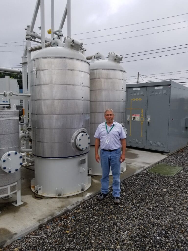 Allen Adriani beside industrial gas vessels